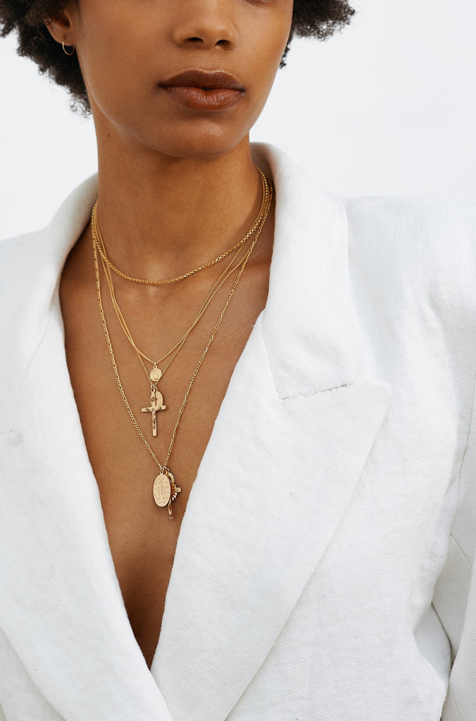 Model wearing 14K 302 Mini Hoops Earrings paired with three layered necklaces  Bagatiba