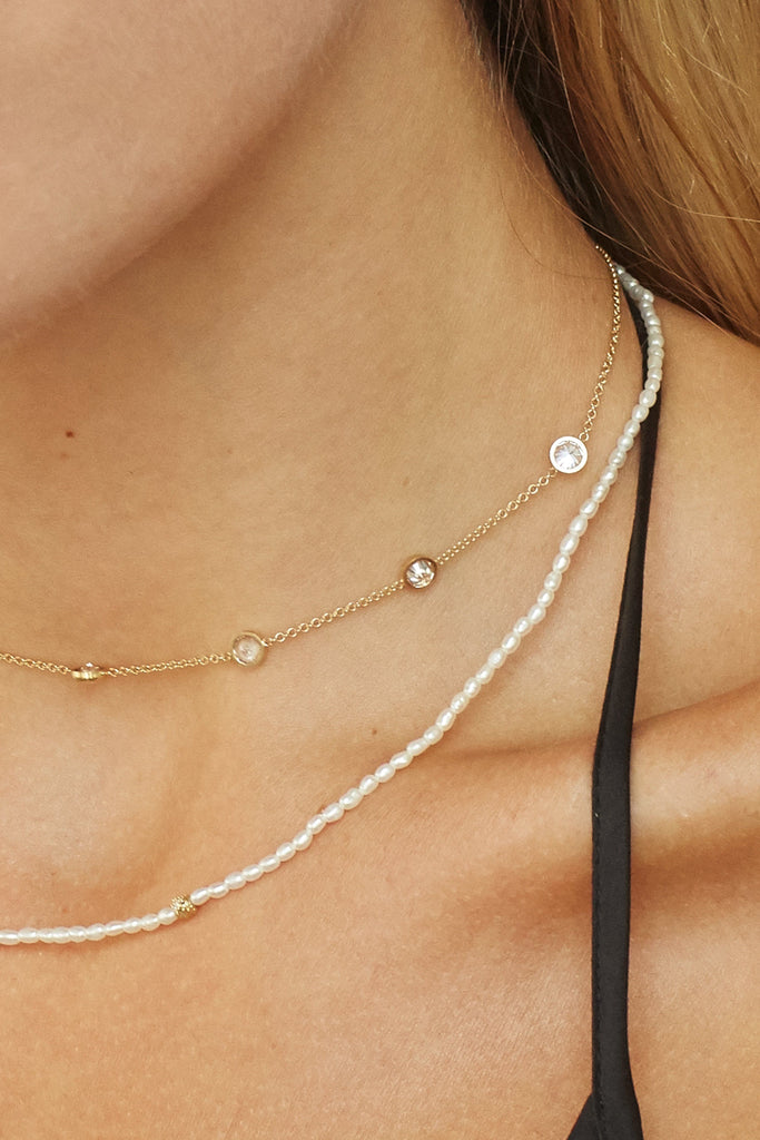 Cropped view on model of 14K Diamond Pearl Necklace layered with princess choker Necklace bagatiba