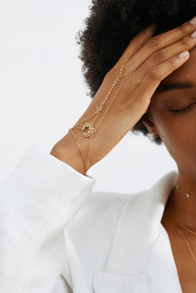 Cropped view of model profile and hand in 14K Emma Finger Bracelet Bracelet Bagatiba