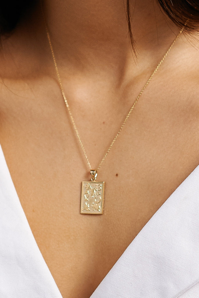 Close up view on model of 16" + 2" Simple Necklace with charm bagatiba