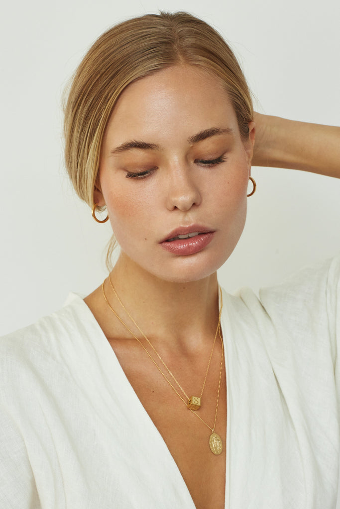 Model wearing 1SM Necklace and Letter block Necklace Bagatiba