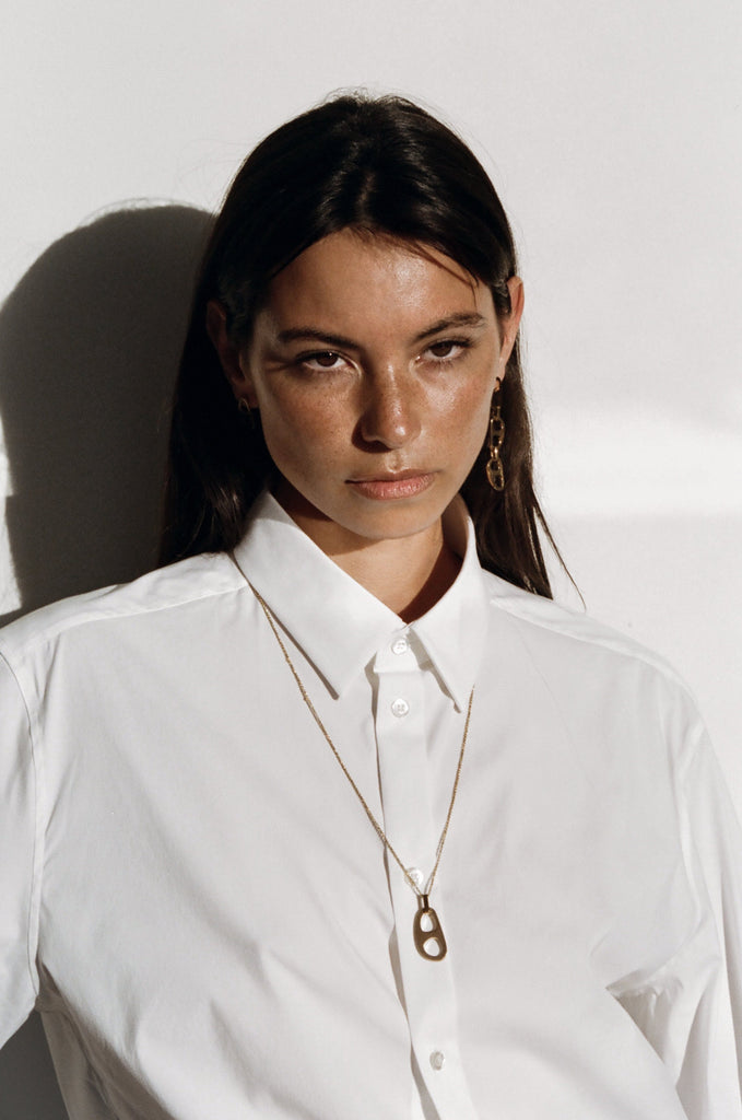 Model wearing Adjustable Gold Tab Necklace and dangle tab earrings  bagatiba