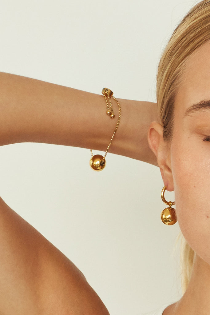 Cropped detail view on model of Adjustable Sphere Bracelet & Sphere Hoops  bagatiba