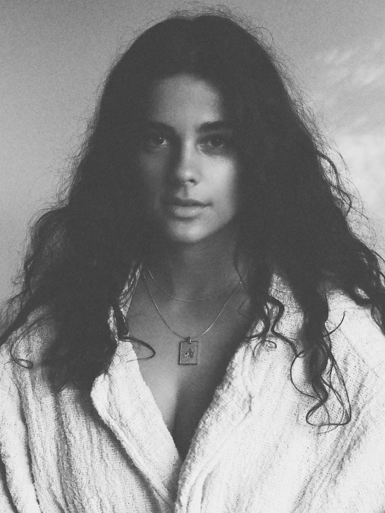Black and White photo of model wearing Aquarius Charm charm Bagatiba