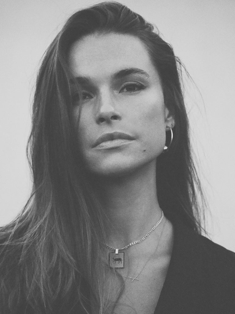 Black and White photo of Model wearing Aries Charm charm Bagatiba
