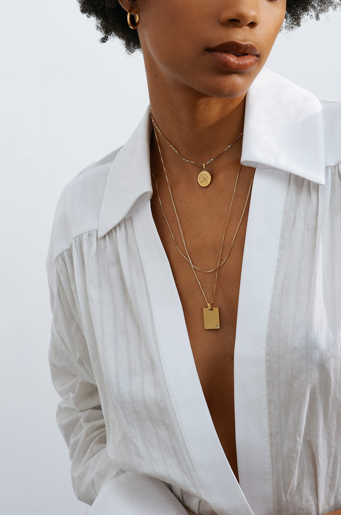 Model wearing layered necklaces including Bagatiba Long Cage Necklace Necklace Bagatiba