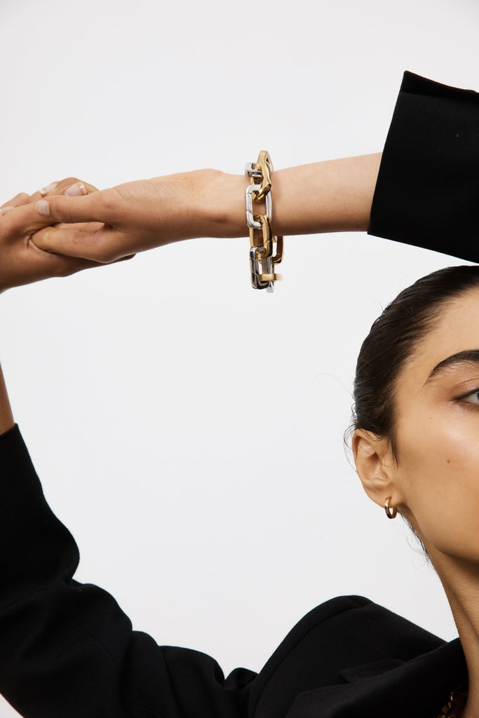 View of Model's wrist with a bracelet made of Brushed Gold Cara Clips & Silver Cara Clips Bagatiba