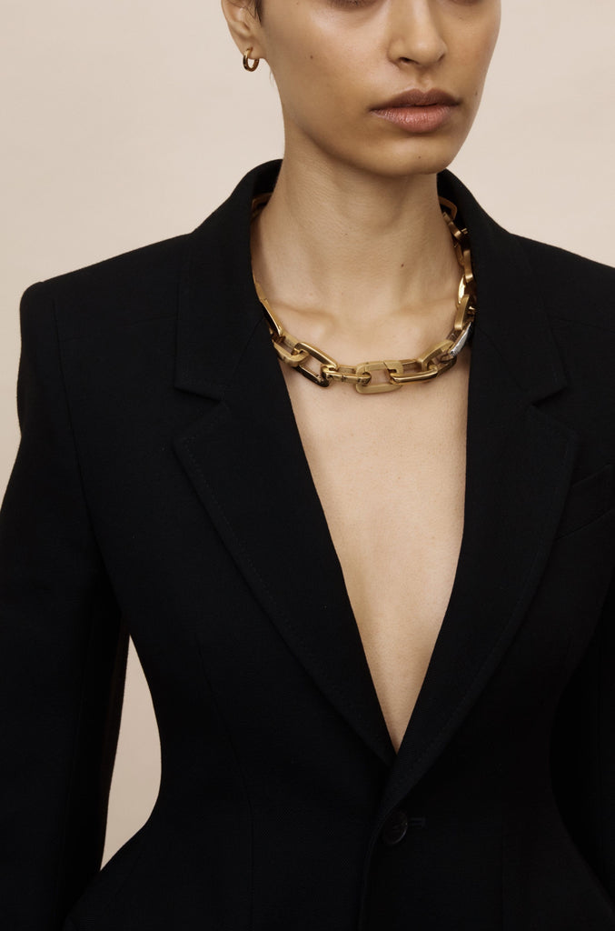 Full view of model wearing a necklace made of Brushed Gold Cara Clip Body Bagatiba