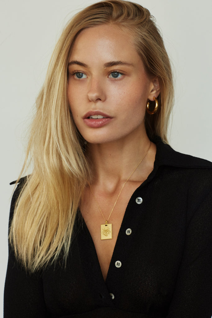 Model wearing the Cancer Charm charm Bagatiba