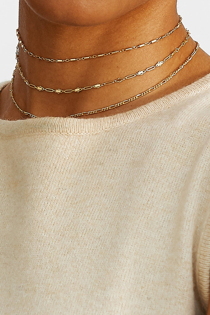 Cropped view on model of Cross Chain Choker with two additional Chokers Bagatiba
