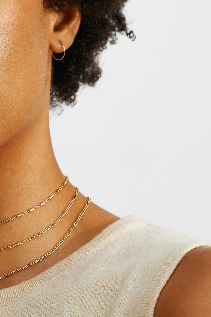 Cropped view on model of 3 chokers including the Cylinder Choker Choker Bagatiba
