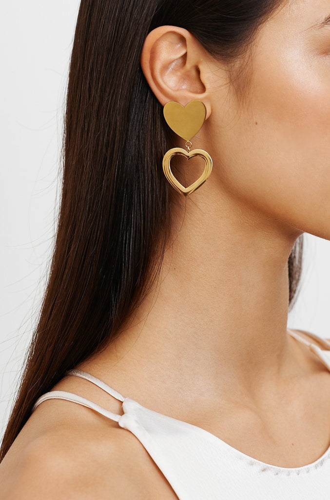 Model profile view wearing Double Heart Stud Earrings Earrings bagatiba