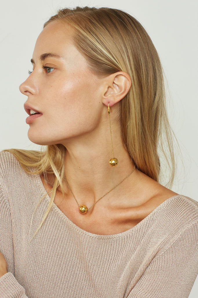 Model profile view wearing Drop Sphere Earrings Earrings bagatiba