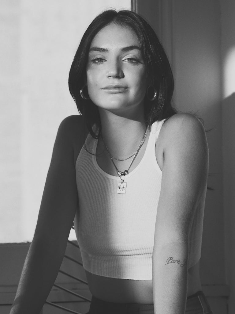 Black and White photo of model wearing the Gemini Charm charm Bagatiba
