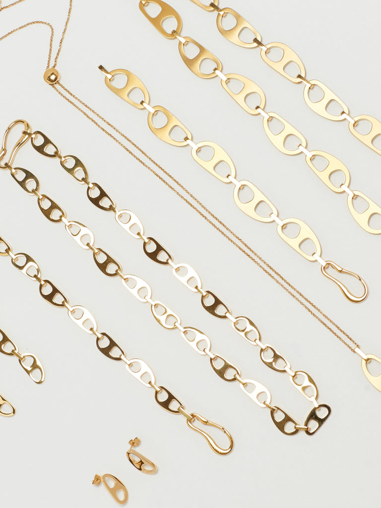 Cropped flat lay view of Gold Brushed Tab Bracelet with Tab Collection bagatiba
