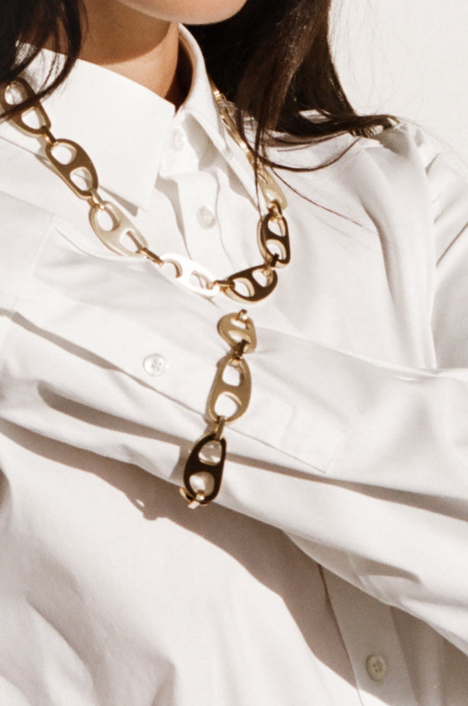 Cropped detail view on model of Gold Brushed Tab Necklace Necklace bagatiba