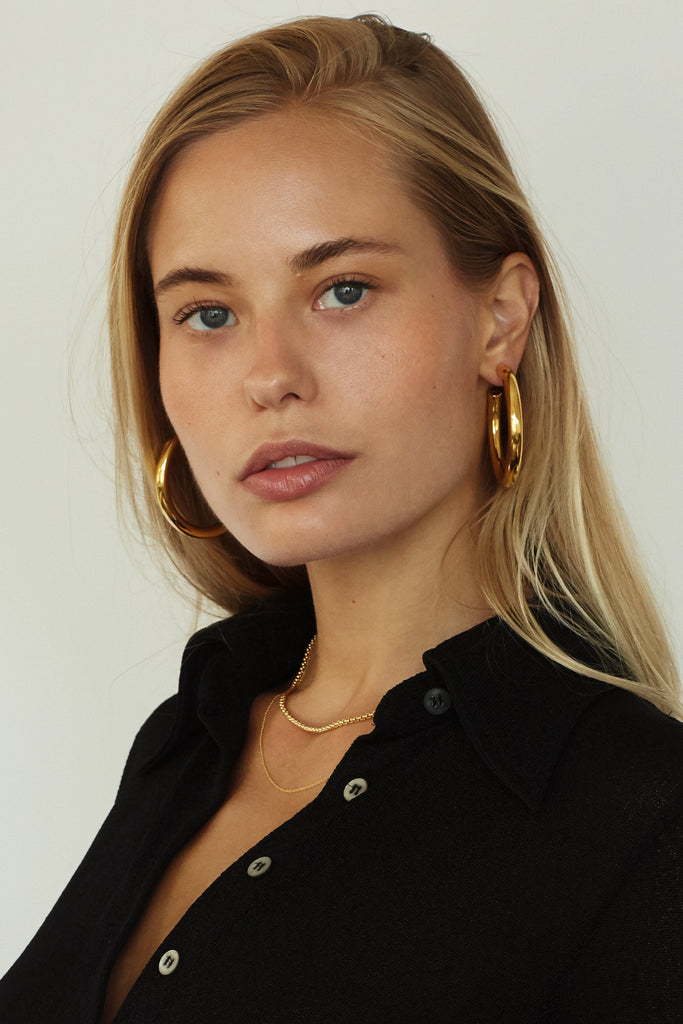 Cropped view of model wearing Gold Hollow Hoops Earrings Bagatiba