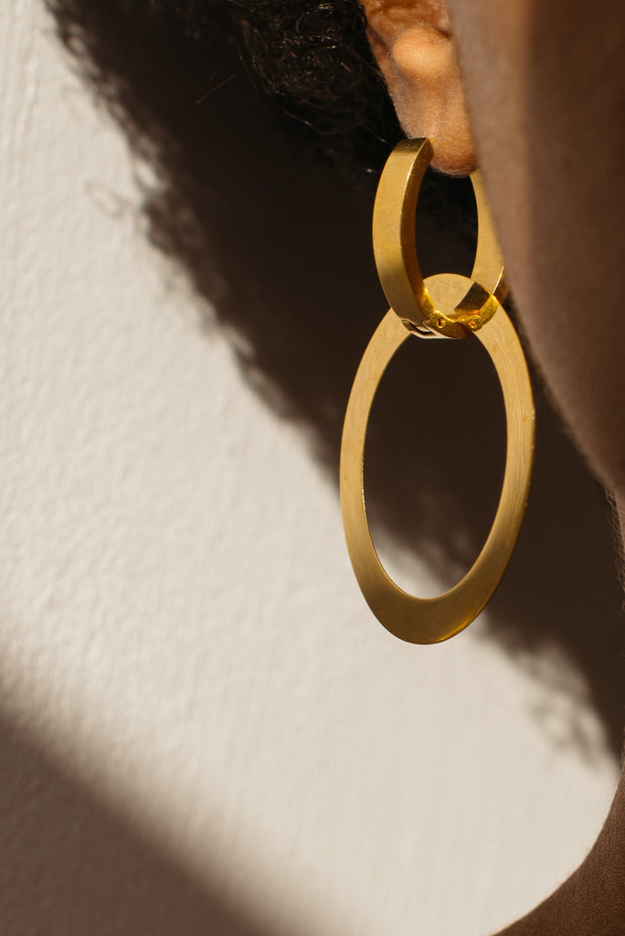 Close detail view on model of Gold Rita Hoops Earrings Bagatiba