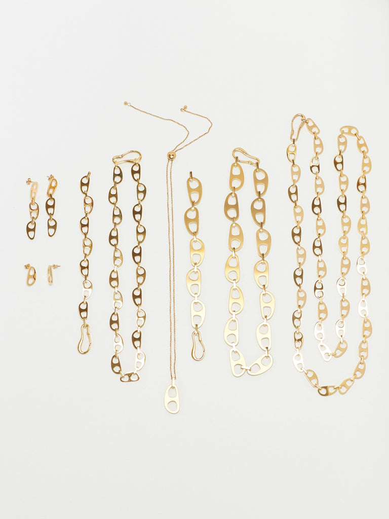 Flat lay of Tab Collection including the Gold Tab Crossbody Belt Body bagatiba