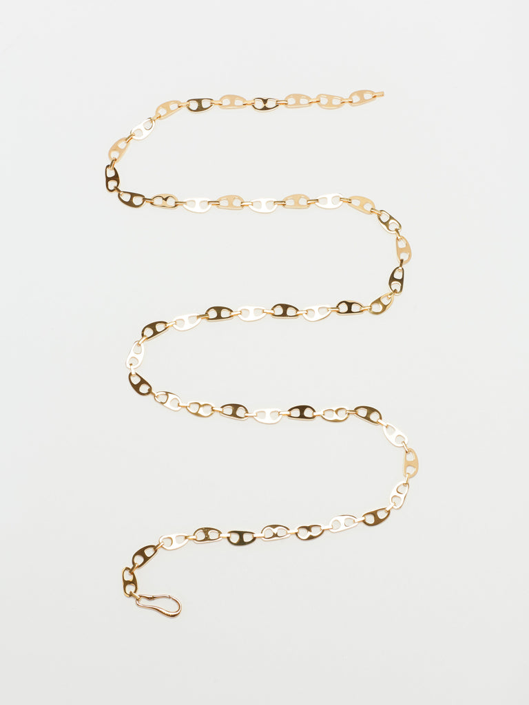 Flat lay of Gold Tab Crossbody Belt Body bagatiba