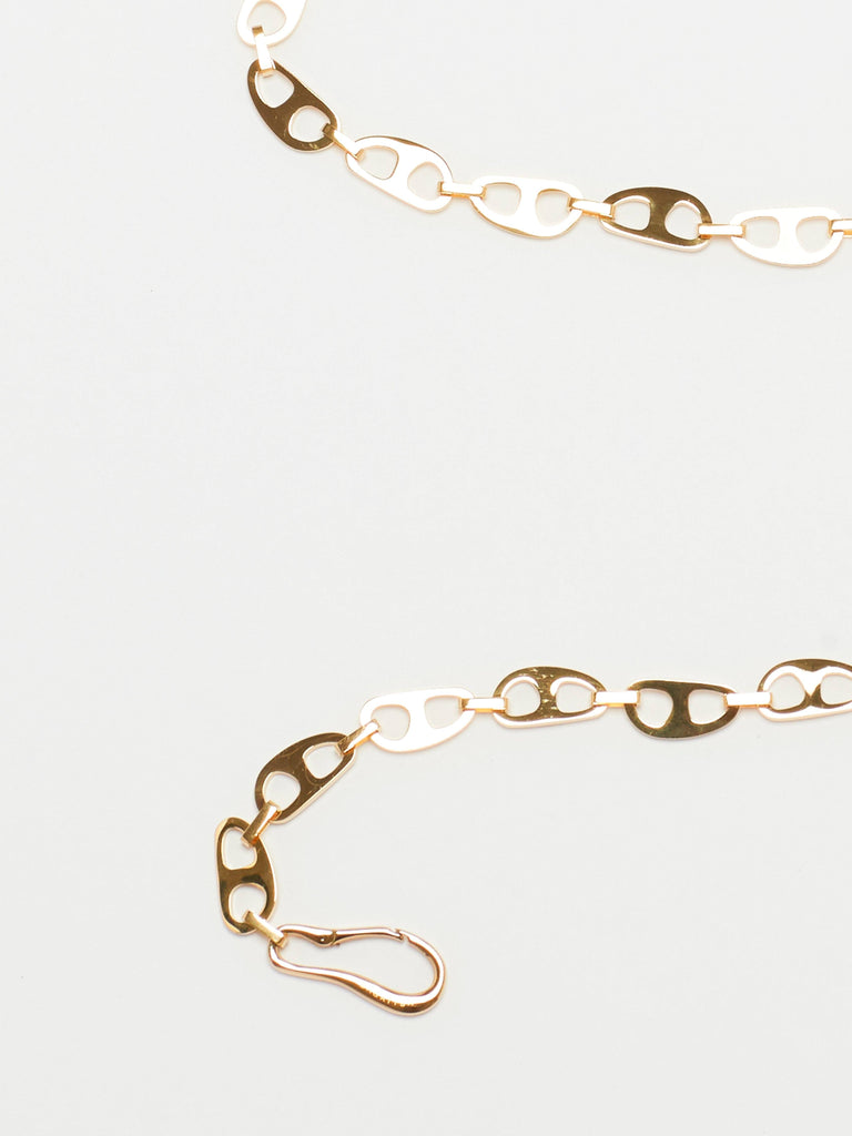 Detail cropped view flat lay of Gold Tab Crossbody Belt Body bagatiba