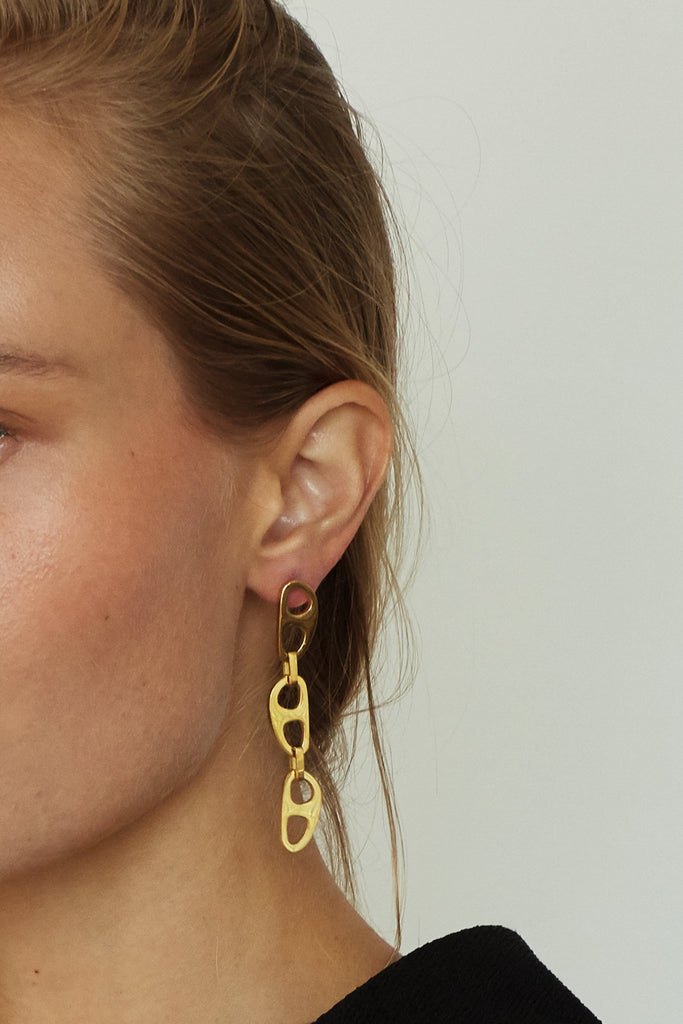 Cropped view on model of Gold Tab Drop Earrings Earrings bagatiba