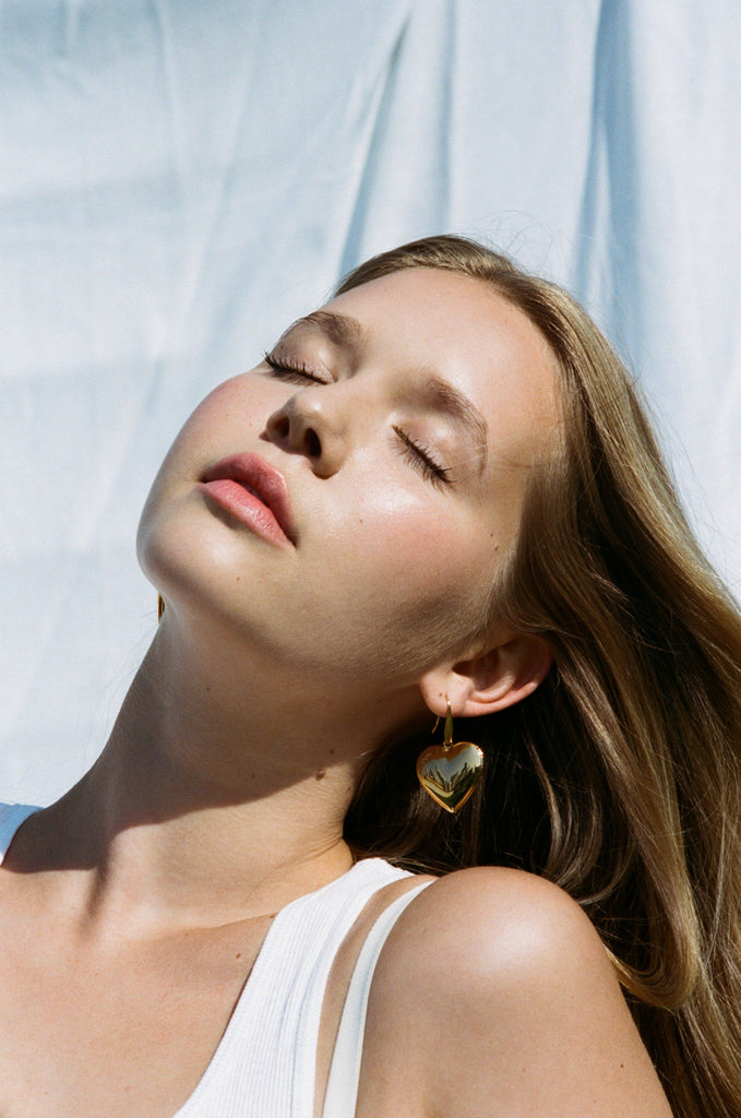 Model in natural light wearing Heart Locket Drop Earrings Earrings bagatiba