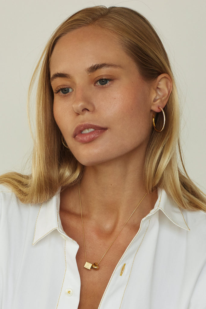 Model profile view wearing Medium Diamond Hoops Earrings Bagatiba