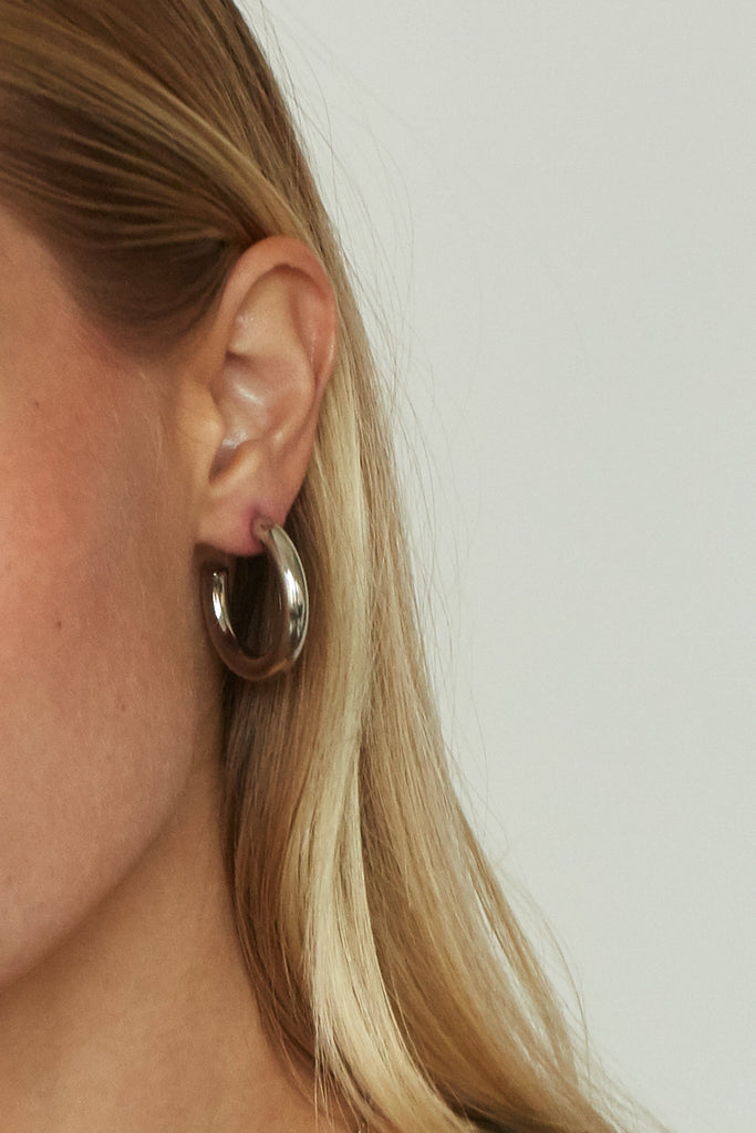 Cropped view on model of Mini Silver Hollow Hoops Earrings Bagatiba