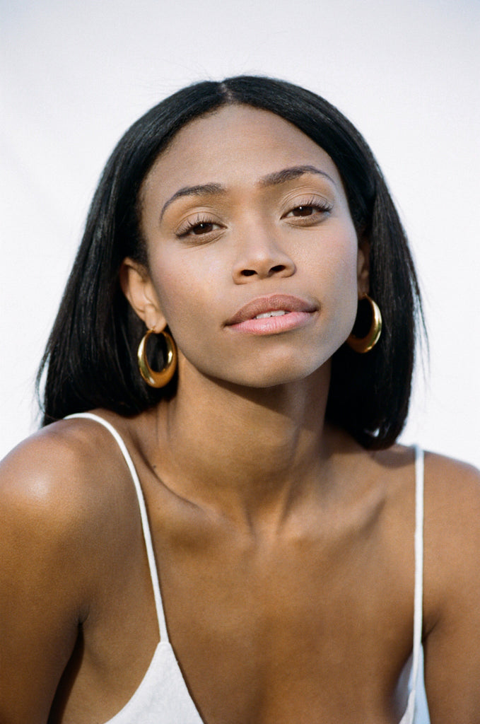 Model wearing the Orb Hoops Earrings in natural light  bagatiba