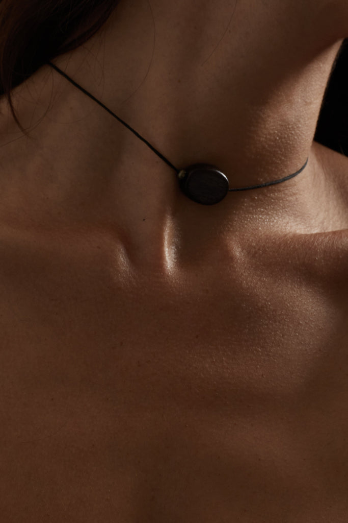 Oval Wood Bead Necklace necklace Bagatiba close up in moody lighting on skin