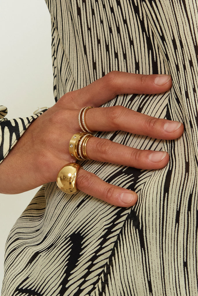 The Polished Gold Ring on hand stacked with about 10 other Rings by Bagatiba