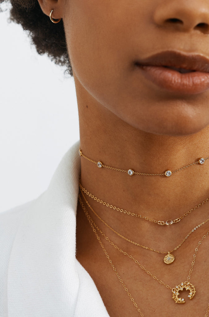 Cropped view of model wearing layered chokers including the Princess Choker by Bagatiba