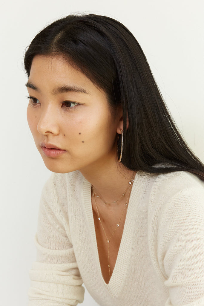 Side view of model wearing the Princess Drop Necklace by Bagatiba