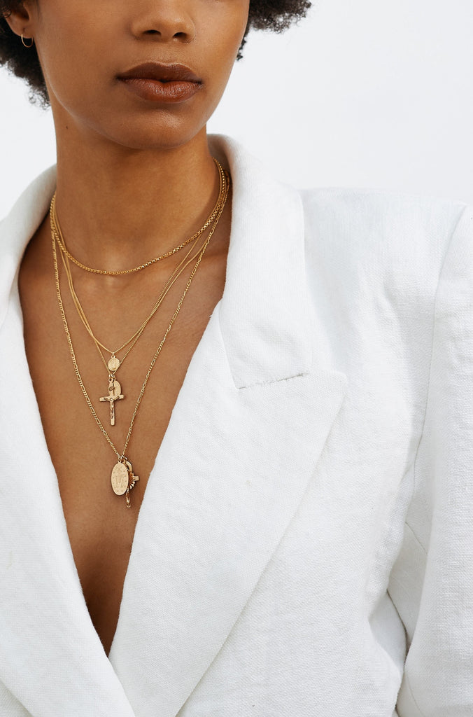 Model wearing a white blazer styled with multiple necklaces including the Roller Choker by Bagatiba