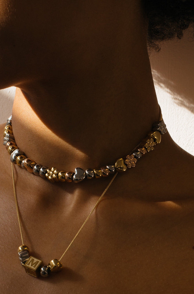 Profile view of model wearing multiple Rose Gold Bead Set Bagatiba