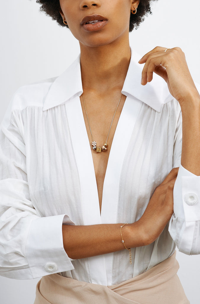 Model wearing "M" Letter Block letters paired with small simple hoops Bagatiba