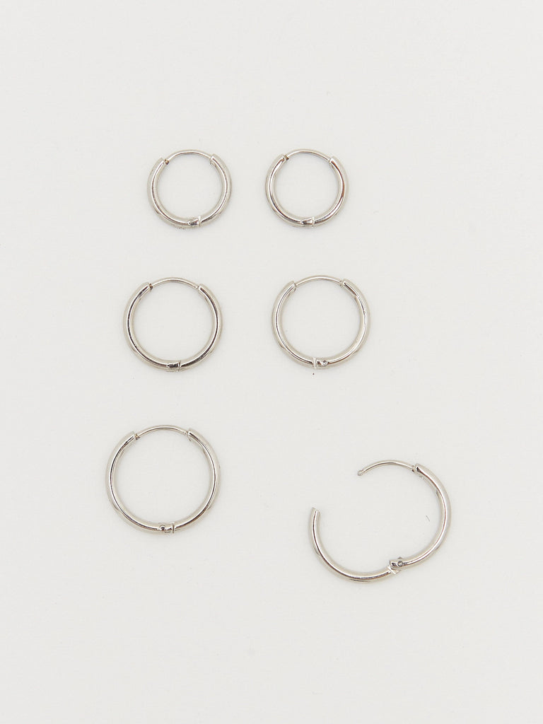 Cropped overhead flat lay view of Set of Silver Eco Huggie Hoops Earrings Bagatiba