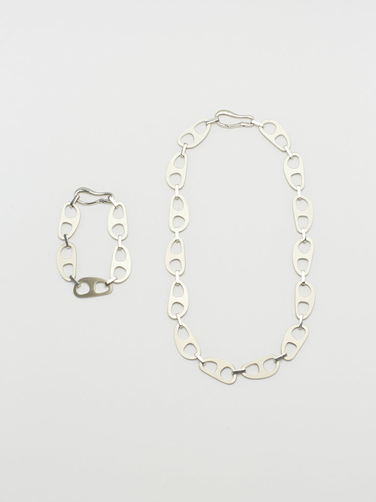 Full view flat lay of Silver Brushed Tab Bracelet and Necklace by  bagatiba