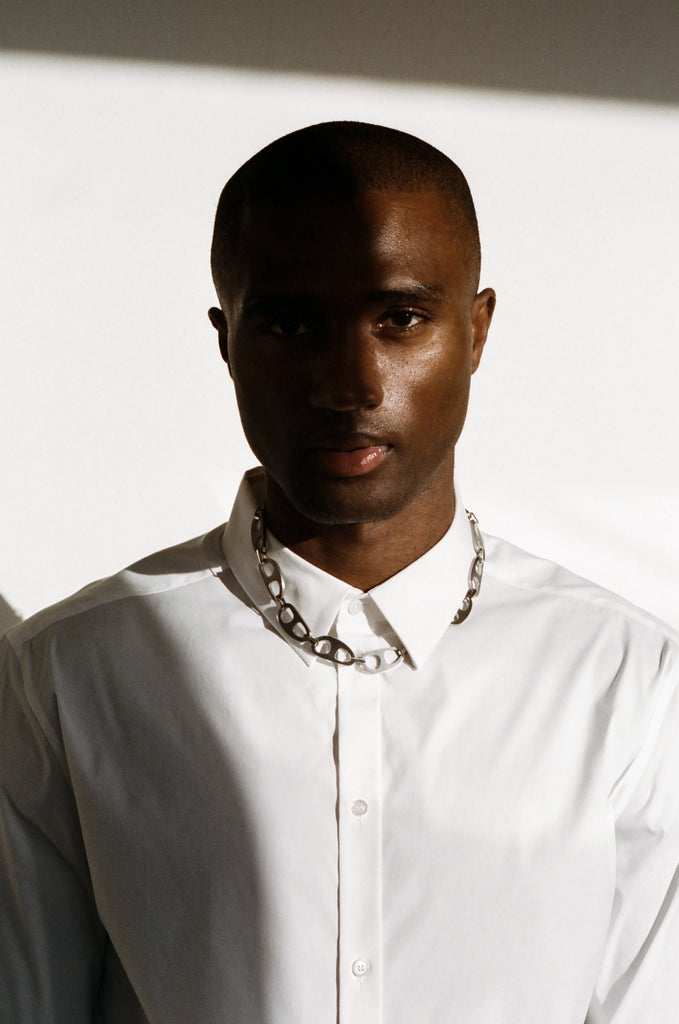 Silver Brushed Tab Necklace worn by a male model standing in natural light  bagatiba