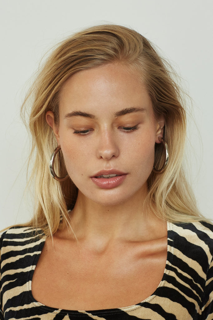 Silver Hollow Hoops Earrings by Bagatiba shown on model