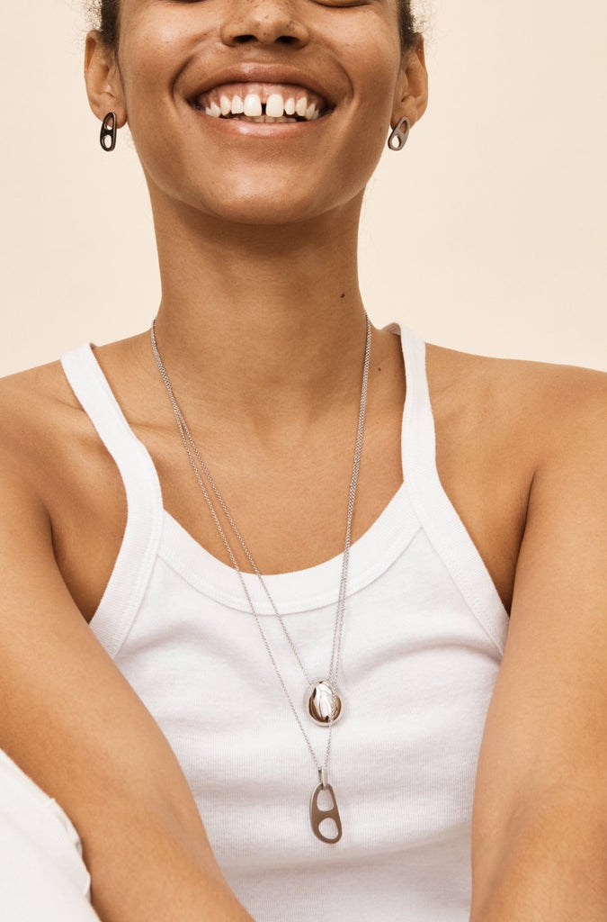 Full view of Model wearing the Silver Orb Necklace styled with the Silver Tab Adjustable  Necklace by bagatiba