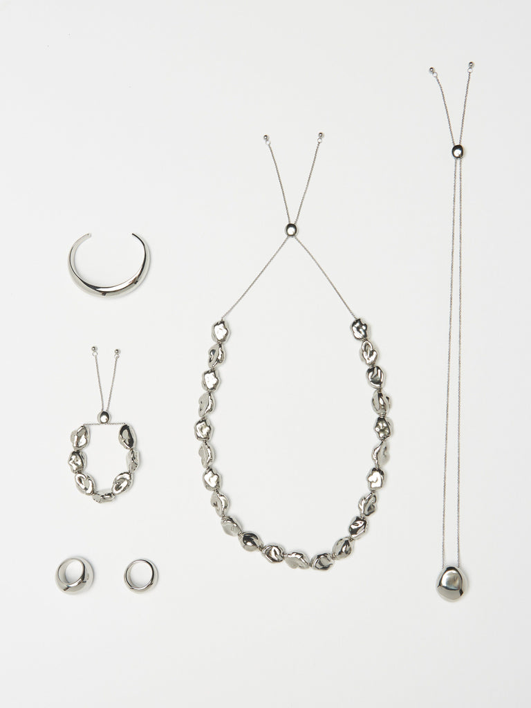 Full view flat lay of Silver Pearl Bracelet, Silver Pearl Necklace and the Silver Orb Collection by bagatiba