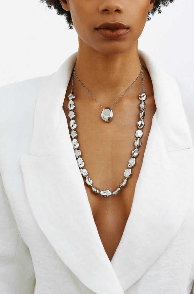 Full view of model wearing the Silver Pearl Necklace and the Silver Orb Necklace bagatiba