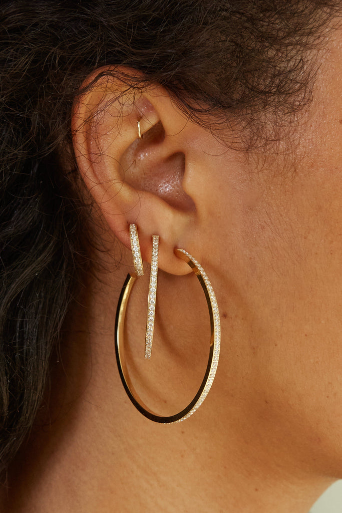 Close up view on model's ear of Small Diamond Hoops Earrings Bagatiba