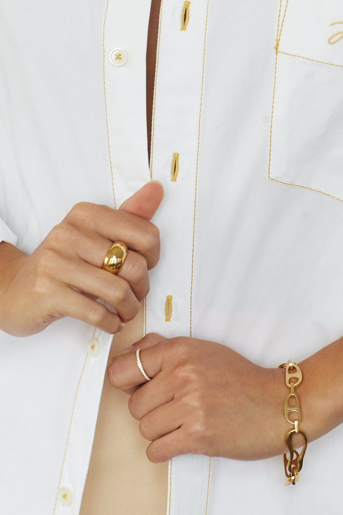 Detail view on wrist of Small Gold Tab Bracelet Necklace bagatiba