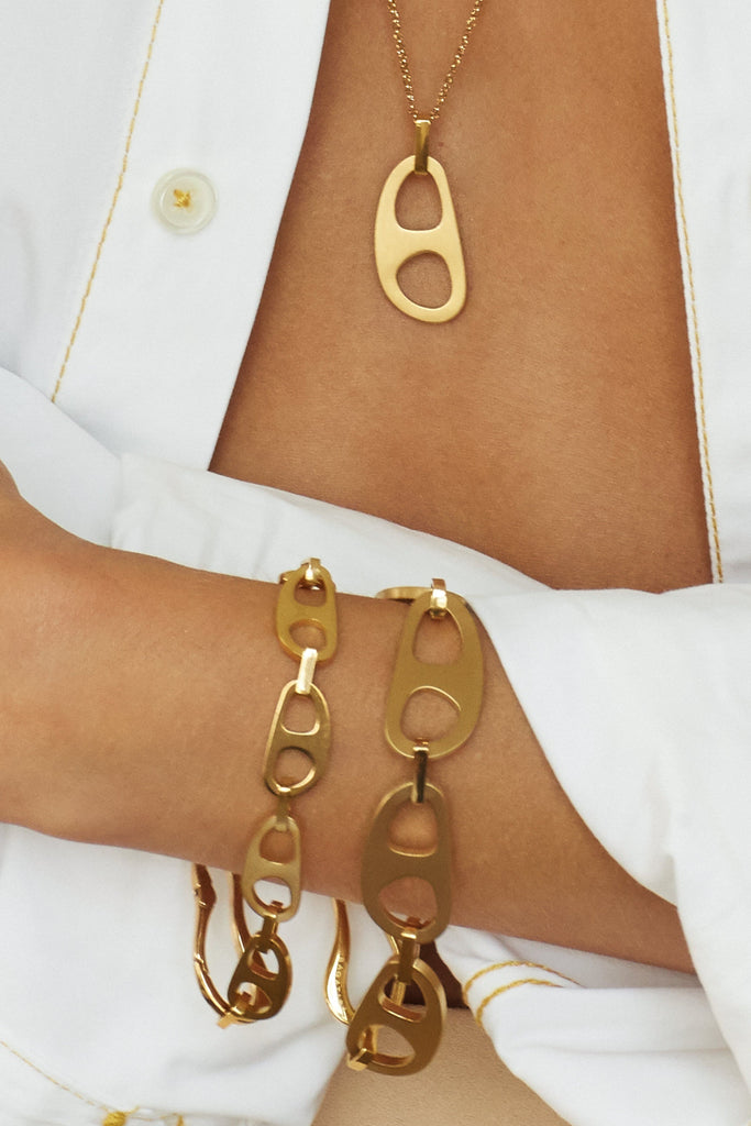 Cropped view on model of the Brushed & Small Gold Tab Bracelet, Adjustable Tab Necklace by bagatiba