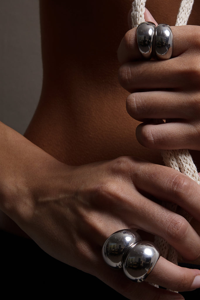 Small Silver Orb Rings stacked next to Large Orb rings