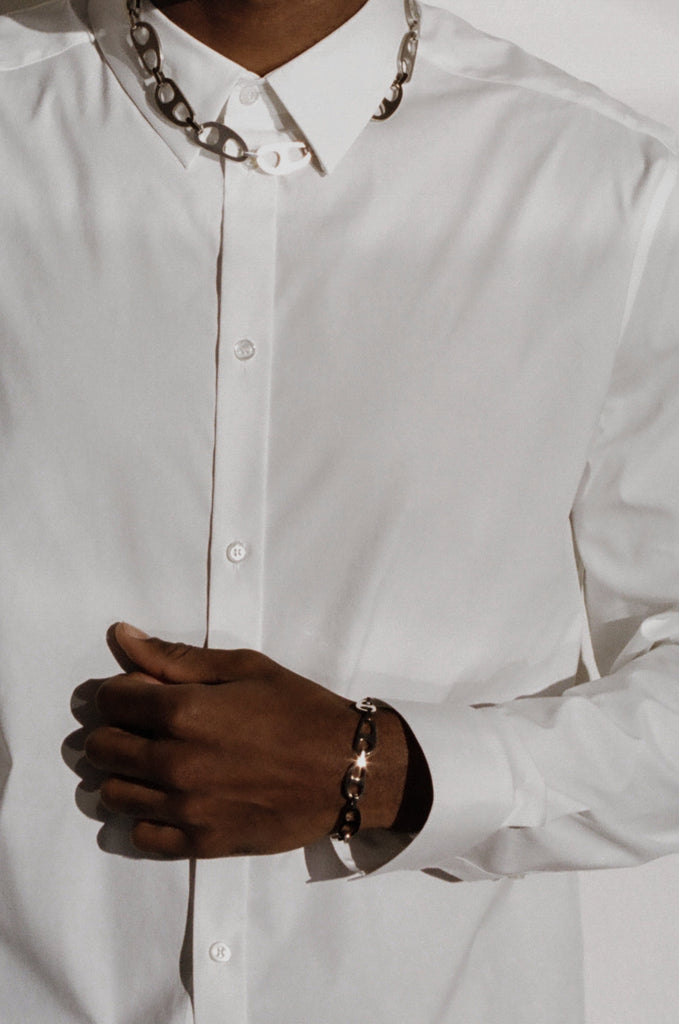 Detail view on male model of Small Silver Tab Bracelet Necklace bagatiba