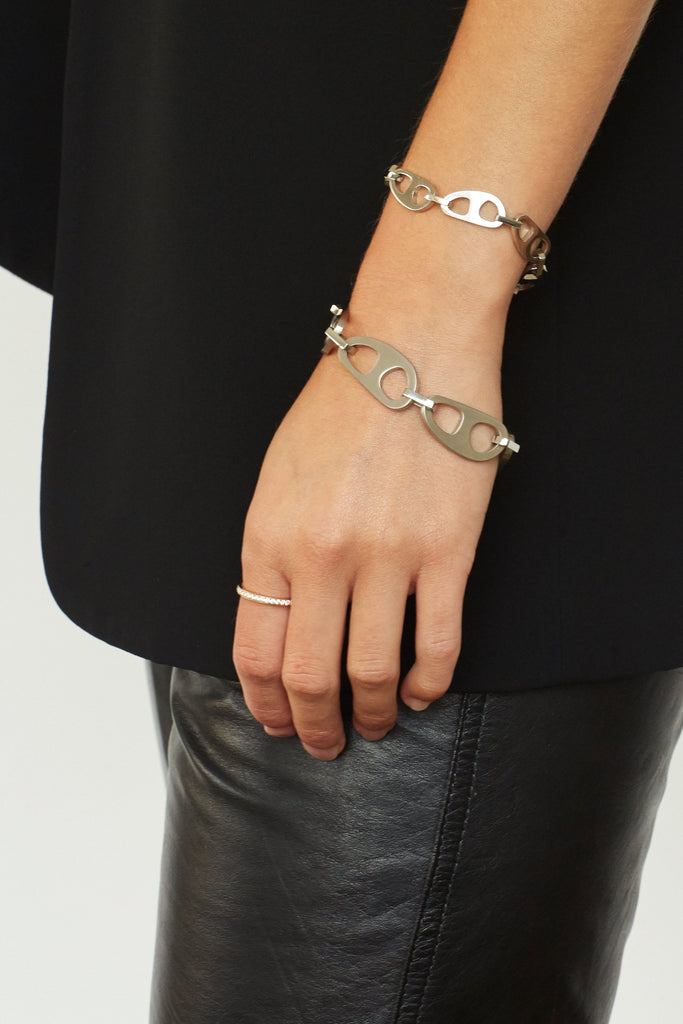 Detail view on wrist of Small Silver Tab Bracelet Necklace bagatiba